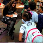 Author Andi Green signs copies of "Worry Woos," for students at PS 20